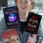 Me standing outside and smiling, holding the books I've read this past week now that we're halfway through February. I finished The Marrow Thieves by Cherie Dimaline, then Read Shaedes of Power by Jenny Grimes, followed By Hyde by Craig Russell. Finally, I started House of Night by Celia Aaron.